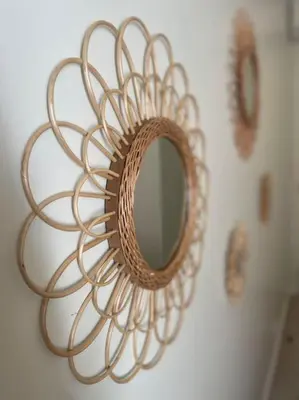 a circular mirror on a wall with two clocks at Appartement Carré d’Or Nice in Nice