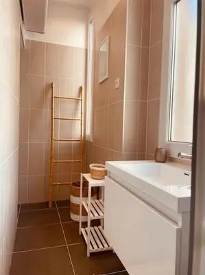 a bathroom with a white sink and a mirror at Appartement Carré d’Or Nice in Nice