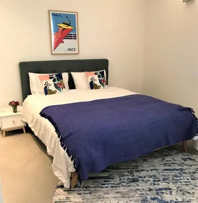 a bedroom with a bed with a purple blanket at LA FONTAINE AP4355 By Riviera Holiday Homes in Villefranche-sur-Mer