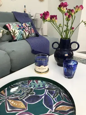 a living room with a table with a vase of flowers at LA FONTAINE AP4355 By Riviera Holiday Homes in Villefranche-sur-Mer
