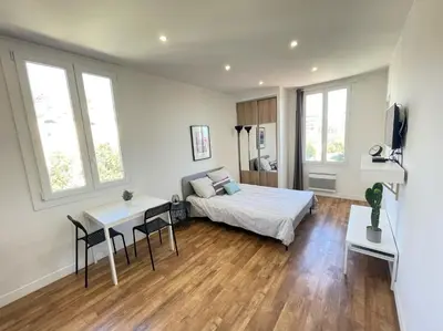 a bedroom with a bed and a table with chairs at Nice Renting - CAMBRAI02 - Studio Beach Sea View - AC - Promenade des Anglais in Nice