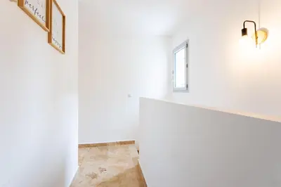 a hallway with white walls and a window at LA CASITA VI4348 By Riviera Holiday HOmes in Falicon