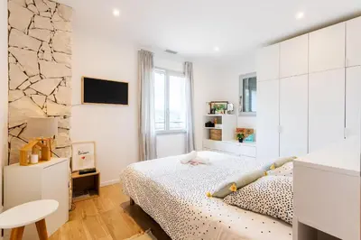 a white bedroom with a bed and a window at LA CASITA VI4348 By Riviera Holiday HOmes in Falicon