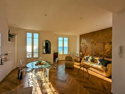 a living room with a table and a couch at Happyfew Palazzo del sol in Nice