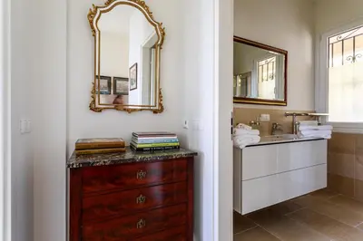 a bathroom with a wooden dresser and a mirror at Sea View Apartment with Private Secure Parking - 2 in Villefranche-sur-Mer