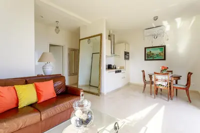 a living room with a couch and a table at Sea View Apartment with Private Secure Parking 3 in Villefranche-sur-Mer