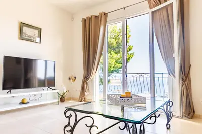 a living room with a glass table and a large window at Sea View Apartment with Private Secure Parking 3 in Villefranche-sur-Mer