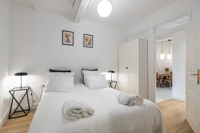 a kitchen and living room with a table and a couch at Chez Collette - Luxury in the Old Nice in Nice
