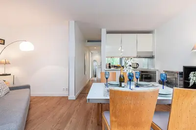 a kitchen and living room with a table and chairs at Central 1 Bdr in Nice