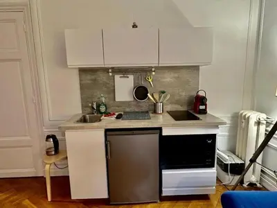 a kitchen with white cabinets and a counter top at Luxurious 2 bedrooms on Promenades des Anglais in Nice