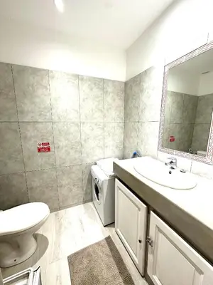a bathroom with a sink and a washing machine at Studio mezzanine sur le port in Nice