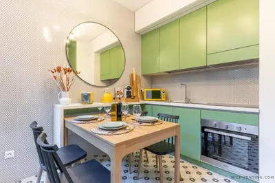 a kitchen with green cabinets and a table with a mirror at Nice Renting - BAVASTRO - Luxurious Loft - 2 BedRoom - AC - Balcony - Trendy Neighborhood in Nice