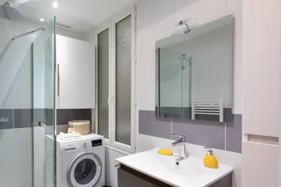a bathroom with a washing machine and a sink at L12 Port window 1Bedroom Wifi 5mins beach & Nice's Cap in Nice