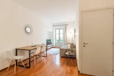 a living room with a table and chairs and a dining room at L13 Central flat 5mins walk to beach AC/Balcon/WIFI in Nice