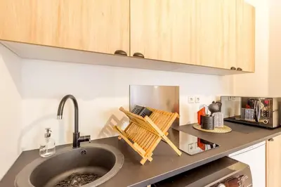 a kitchen counter with a sink and a microwave at L13 Central flat 5mins walk to beach AC/Balcon/WIFI in Nice