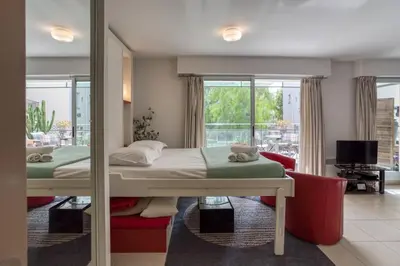 a bedroom with a bed and a living room at L18 Central Parking terrace AC 10mins walk to beaches in Nice