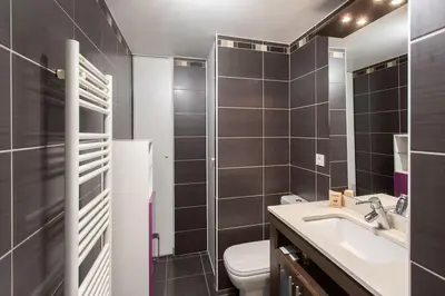 a bathroom with a toilet and a sink and a mirror at L18 Central Parking terrace AC 10mins walk to beaches in Nice
