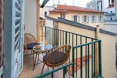 a balcony with two chairs and a table on a balcony at L19 1BDR Massena central 2mins Sea/PromenadeAC/Balcony in Nice