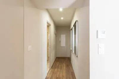 a hallway with white walls and a wooden floor at L19 1BDR Massena central 2mins Sea/PromenadeAC/Balcony in Nice