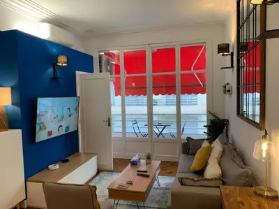 a living room with a couch and a table at L24 Meyerbeer Promenade 1min SEA & Negresco AC/Balcony in Nice