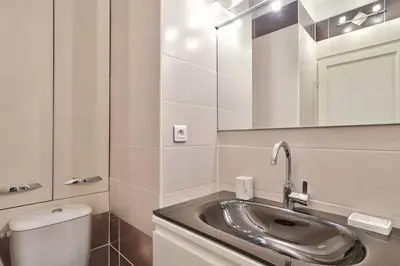 a bathroom with a sink and a toilet and a mirror at L29 Lenval beach at 1min walk to Sea front AC Balcony in Nice