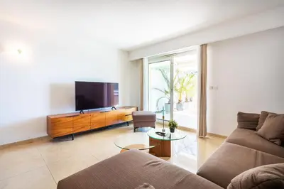 a living room with a couch and a tv at EZE VISTA AP4328 By Riviera Holiday Homes in Èze