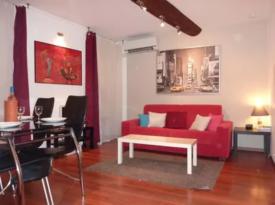 a living room with a red couch and a table at Vieux Nice 2 pièces Appartement SAN REMO in Nice
