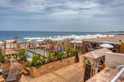 a resort with a swimming pool and the ocean at L39 Suite Promenade des Anglais, Vue Mer Terrasse&WIFI in Nice