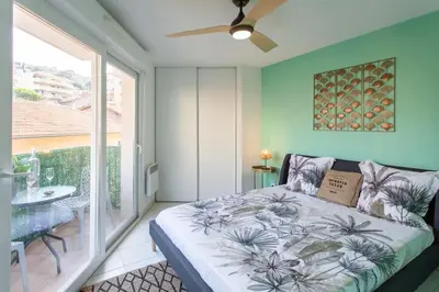 a bedroom with a bed and a large window at L44 1BDR Flat 10mins walk to port/Balcon, Parking, AC in Nice