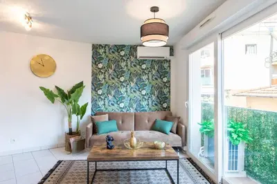 a living room with a couch and a table at L44 1BDR Flat 10mins walk to port/Balcon, Parking, AC in Nice