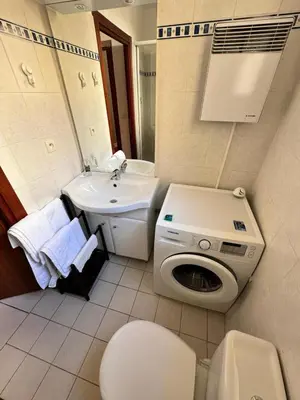 a white bathroom with a sink and a toilet and a sink at Grimaldi Central AC 2 terraces Wifi 5mins SEA in Nice