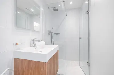 a white bathroom with a sink and a shower at FEEL HOME - GRASSEUIL in Saint-Jean-Cap-Ferrat