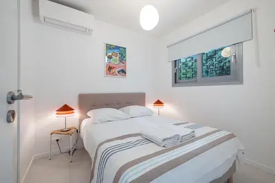a white bedroom with a bed and two windows at FEEL HOME - GRASSEUIL in Saint-Jean-Cap-Ferrat