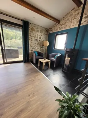 a living room with blue walls and a fireplace at Chaleureuse bergerie rénovée. in Tourrette-Levens