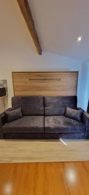 a brown couch in a room with a wooden floor at Vieux Nice a 2min de la mer in Nice
