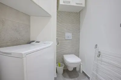 a white bathroom with a toilet and a sink at Maison Bianchi - Lamartine in Nice