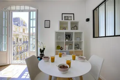 a white dining room with a white table and chairs at Maison Bianchi - Lamartine in Nice
