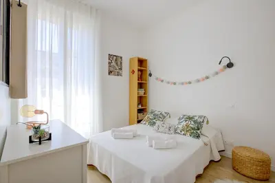 a white room with two beds and a window at Maison Bianchi - Lamartine in Nice