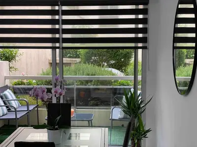 a room with a table and chairs and a window at Superbe appartement carré Delfino Port de Nice in Nice