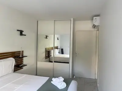 a bedroom with a bed and a mirrored closet at Superbe appartement carré Delfino Port de Nice in Nice