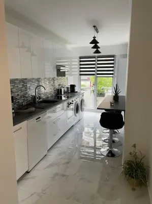 a white kitchen with a sink and a dishwasher at Superbe appartement carré Delfino Port de Nice in Nice