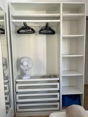 a white closet with white shelves and a fan at Nice - Appartement T3 rénové de 50 M2 classé 2 étoiles in Nice