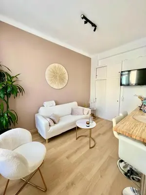 a living room with a white couch and a table at Nice - Appartement T3 rénové de 50 M2 classé 2 étoiles in Nice
